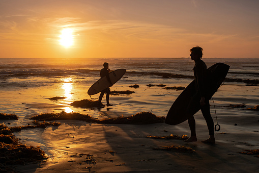 Surfers on Swami's Beach, Encinitas, Cardiff-by-the-Sea on December 28, 2023 during large swell at California coast. San Diego area.