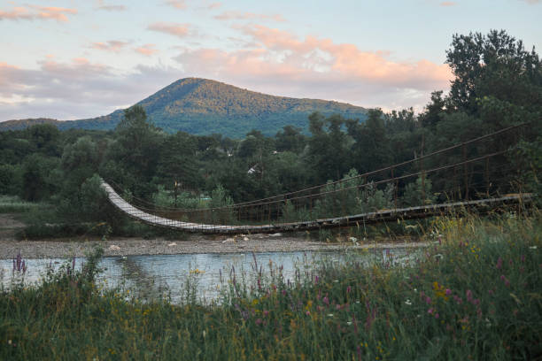 istock Suspension bridge over a mountain river. Natural landscape. 1894679500