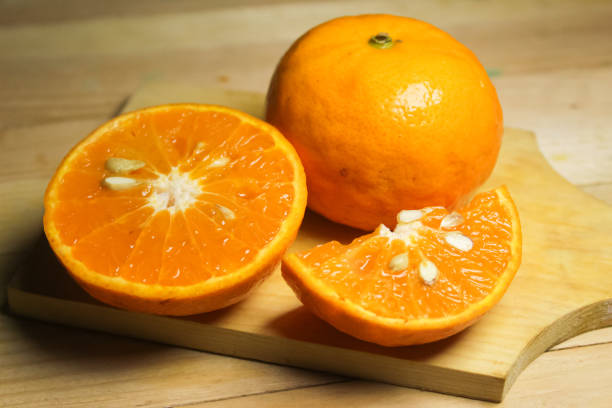 istock sliced ​​oranges on a wooden table 1894714358