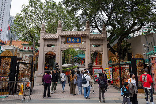 Hong Kong - December 30, 2023 : People at the Wong Tai Sin Temple, Kowloon, Hong Kong. It is a Taoist temple established in 1921. Wong Tai Sin Temple is one of the most famous temples in Hong Kong.