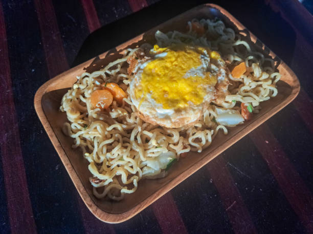 istock Tasty Instant Fried Noodles. Served With Fried Omelette Eggs, Cabbage And Chopped Chives Green Onions. Mi Goreng Instant Dengan Telur. Food Menu. 1894753055