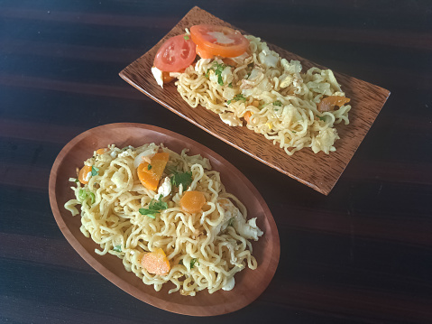 Delicious Instant Fried Noodles (Mi Goreng Instant). Served With Tomato Sliced, Cabbage And Chopped Chives Green Onions. Food Menu