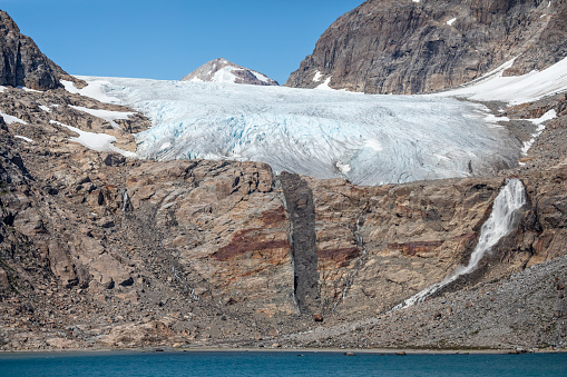 Close up of  glacier and meltwater waterfall in Prince Christian Sound, South Greenland