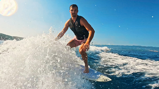 Man Experiencing the Thrill of Wakeboarding,Gliding on Shimmering Waves on a Beautiful and Exciting Sunny Day at Sea,Creating Unforgettable Moments of Pure Fun and Happiness.