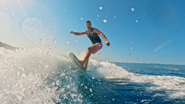 istock Man Skillfully Wakeboarding in the Sea on a Bright Sunny Day 1894780195