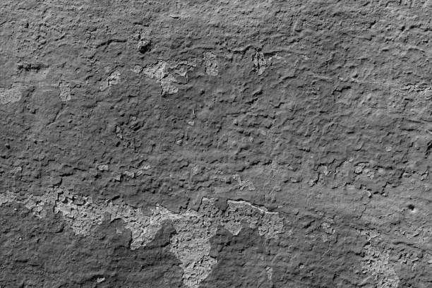 istock Light grey concrete wall with deep scratches and chips. Various variations of abrasions. 1894781780