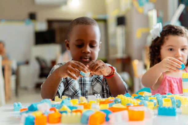 istock African little boy preschool playing with colored blocks in a kindergarten 1894795574