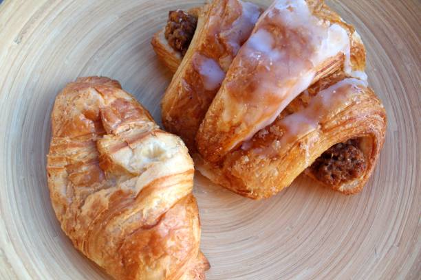 Croissant and nut croissant on a bamboo bowl. Close-up.