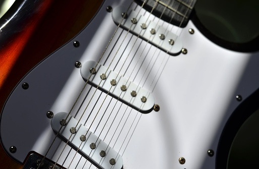 Electric black guitar on a white background