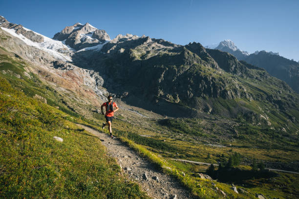 istock Trail runner bounds along mountain trail 1894926187