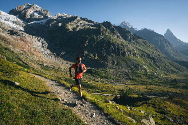 istock Trail runner bounds along mountain trail 1894927259