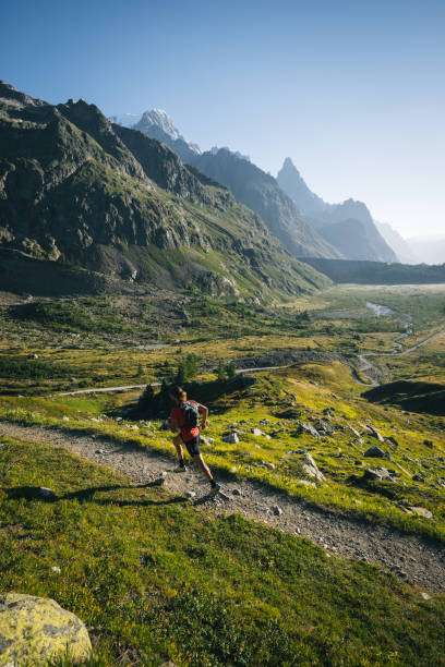 istock Trail runner bounds along mountain trail 1894927812
