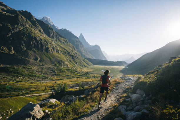 istock Trail runner bounds along mountain trail 1894928843