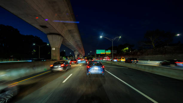 istock Nighttime commute through Queens: Van Wyck Expressway passes under the monorail bridge, leading to JFK airport. Driving plate 1894945313