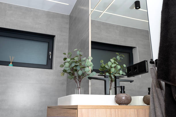 istock LED light strips mounted in the wall and ceiling in a modern bathroom, window visible. 1895012474