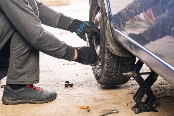 istock A man unscrews a car wheel in a garage. Replacing car wheels 1895040807