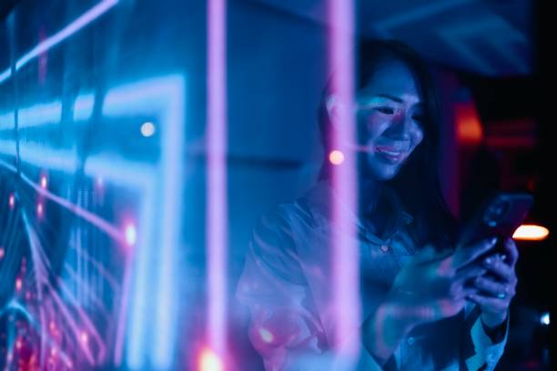 istock Woman using her smartphone in the futuristic office space 1895045435