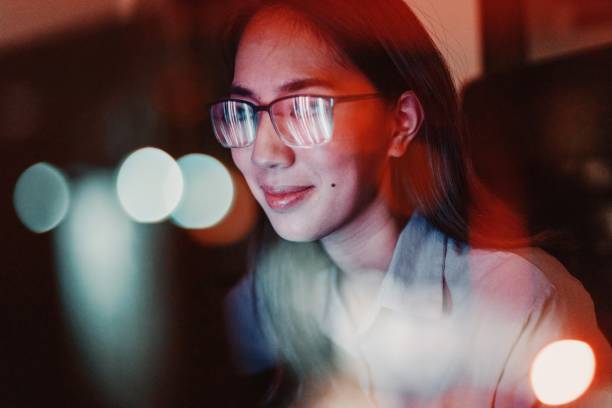 Woman with eyeglasses looking at the computer