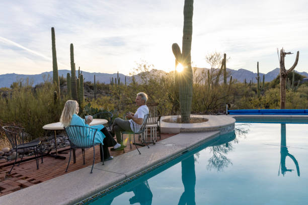 istock Mature couple relax by pool at sunrise 1895072070