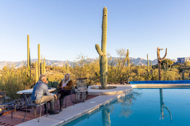 istock Mature couple relax by pool at sunrise 1895076211