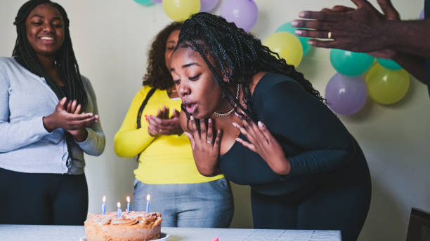 istock Daughter blows out the candles 1895117893