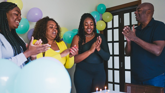 Black family sings happy birthday to daughter