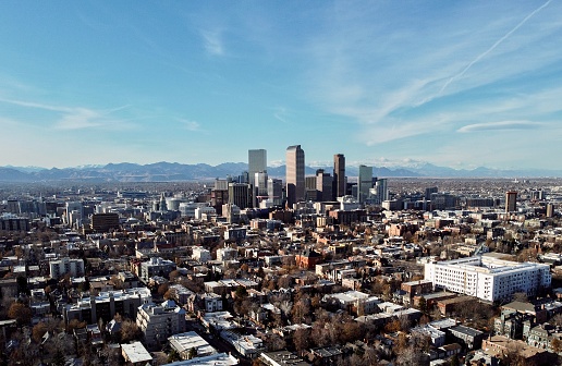 Aerial view of downtown Denver over the Rocky Mountains