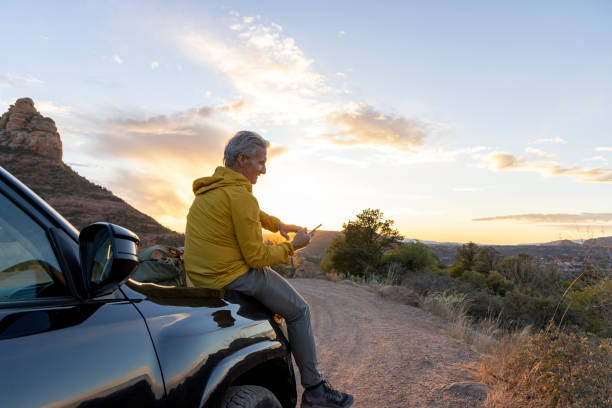istock Mature man uses mobile phone from vehicle 1895139301