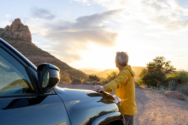 istock Mature man watches sunset from vehicle 1895141066
