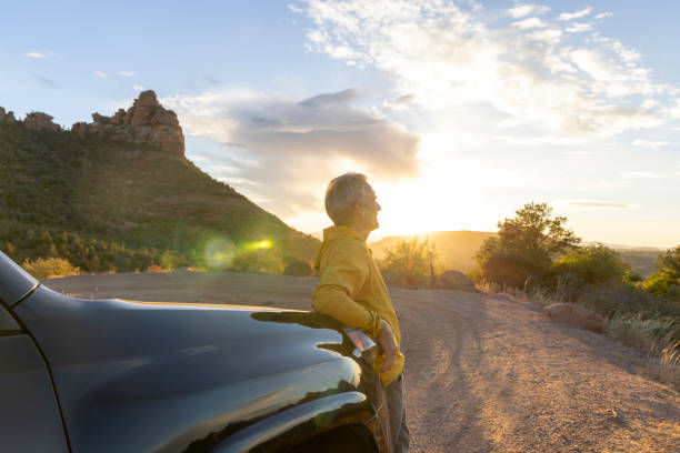 istock Mature man watches sunset from vehicle 1895141076