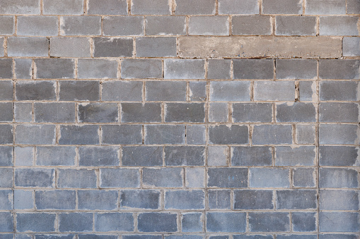 gray concrete brick wall with cancelled window, texture and flat full-frame background.