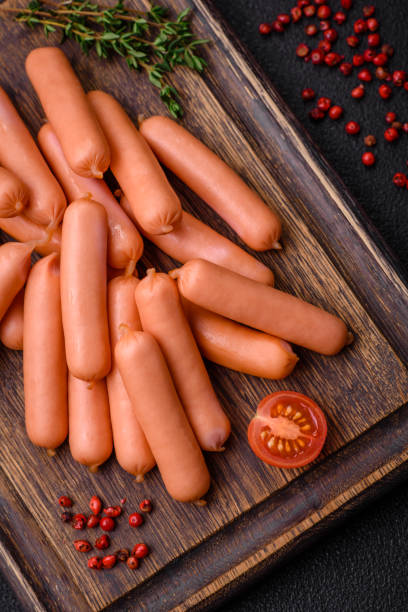 istock Delicious small sausages with salt, spices and herbs 1895184294