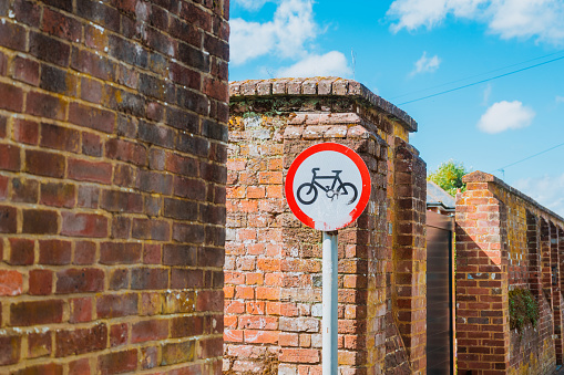 No cycling sign in front of a brick wall