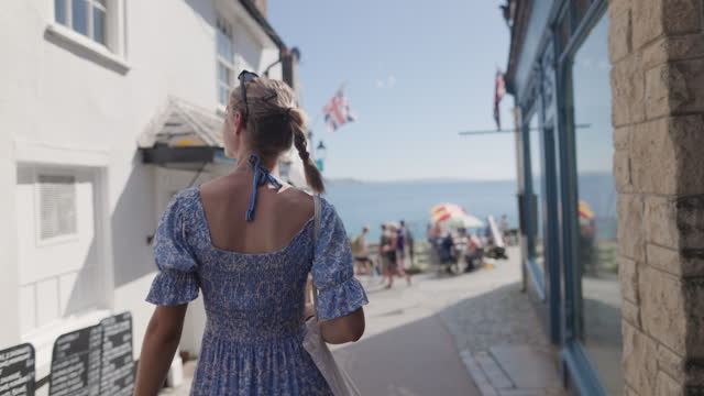 Teenage girl walking in Lyme Regis, Dorset, United Kingdom