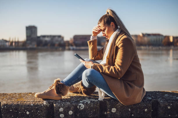 istock Sad woman with mobile phone 1895248946