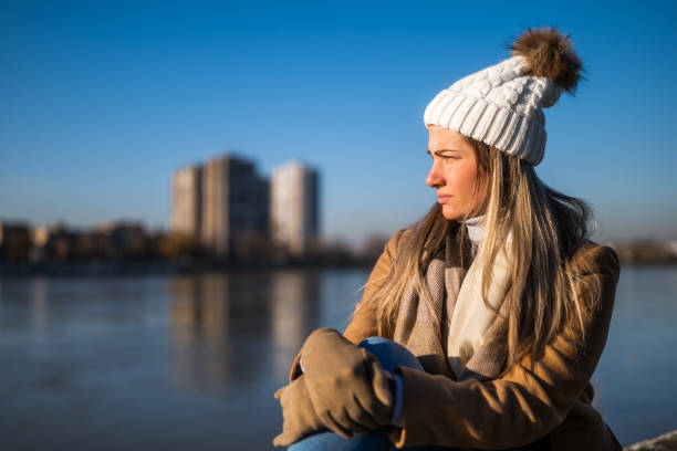 istock Sad woman in warm clothing 1895251068