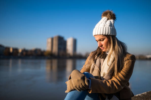 istock Sad woman in warm clothing 1895251072