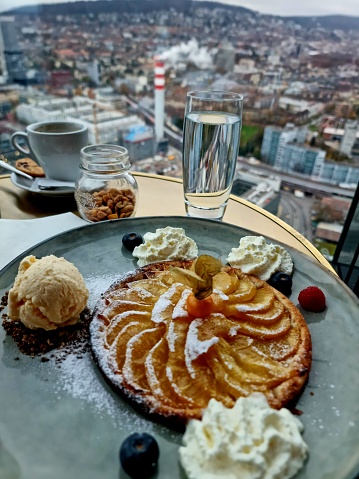Apple pie with Zurich City in the background. The image was captured inside the Prime Tower during autumn season.