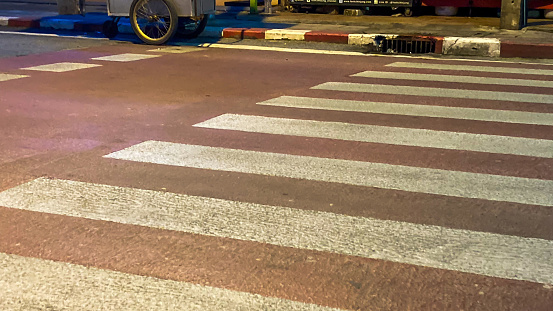 Crosswalk in front of school at night.