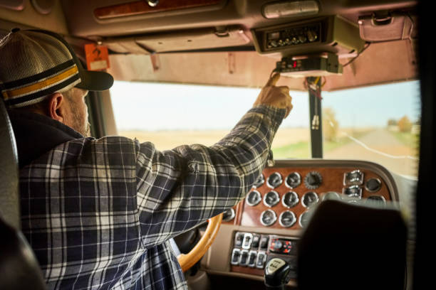 istock Farmer driving tractor on road along the farm 1895290888