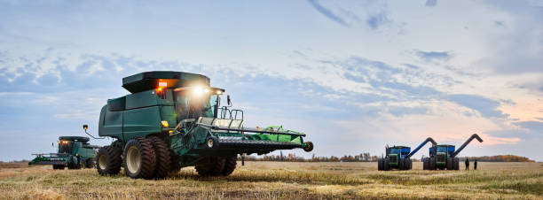 Combine harvest machine outside on farm field during evening
