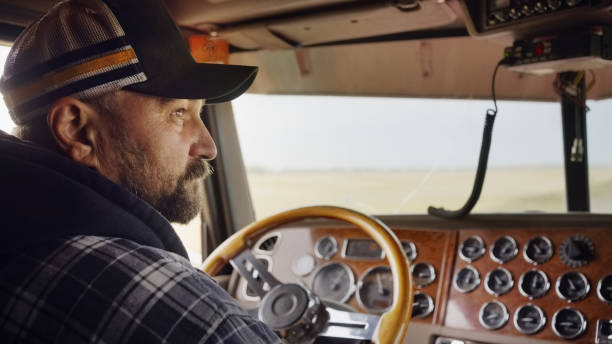 Mature farmer driving a tractor in field