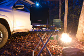Overlanding campsite with propane camp fire pit and camping stove heating oven