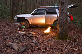 Overlanding campsite with propane camp fire in winter with warm tone