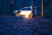 Overlanding campsite with propane camp fire in winter with cool color temperature