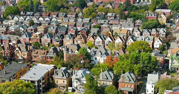 Aerial shot of large Victorian houses in Friendship, a neighborhood in the East End of Pittsburgh, Pennsylvania, on a sunny morning in Fall.