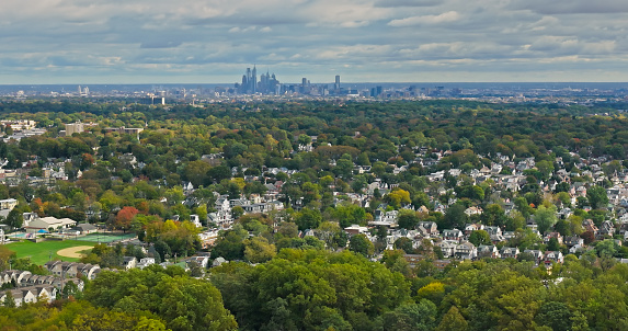 Aerial shot of Haverford, a town in Delaware County, Pennsylvania to the west of Philadelphia on an overcast day in fall.  The downtown Philadelphia skyline is visible in the distance. Haverford is one of the towns of the Philadelphia Main Line.