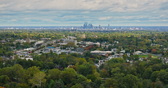 Aerial shot of Haverford, a town in Delaware County, Pennsylvania to the west of Philadelphia on an overcast day in fall.  The downtown Philadelphia skyline is visible in the distance. Haverford is one of the towns of the Philadelphia Main Line.