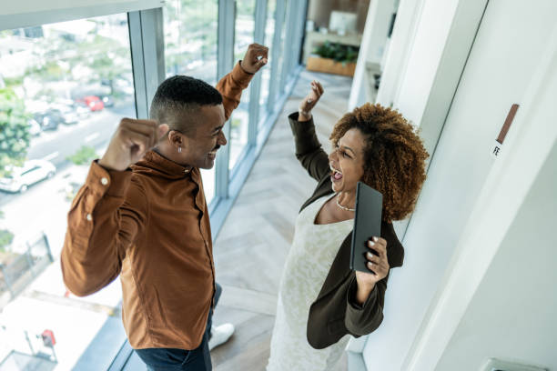istock Coworkers dancing and celebrating on corridor at office 1895390859
