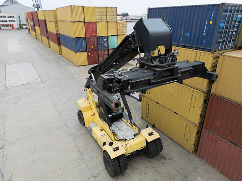 Crane lifting up container on international port